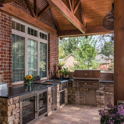 Example of a large mountain style backyard tile patio kitchen design in Nashville with a roof extension