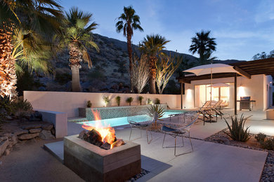 Example of a large trendy backyard concrete paver patio design in Los Angeles with a fire pit and no cover