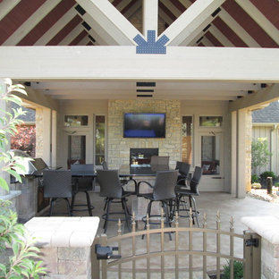 Ispirazione per un grande patio o portico american style dietro casa con pavimentazioni in cemento e un tetto a sbalzo
