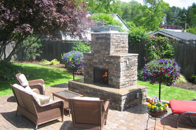 Patio - mid-sized rustic backyard brick patio idea in Other with a fire pit and no cover