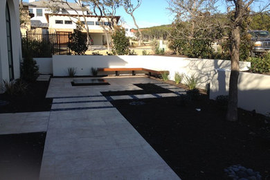 Patio fountain - mid-sized contemporary backyard concrete paver patio fountain idea in Austin with no cover