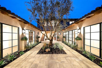 Patio - large mediterranean courtyard stamped concrete patio idea in San Diego with no cover