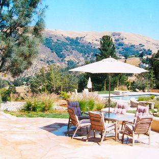 Patio - large mediterranean backyard stone patio idea in San Francisco