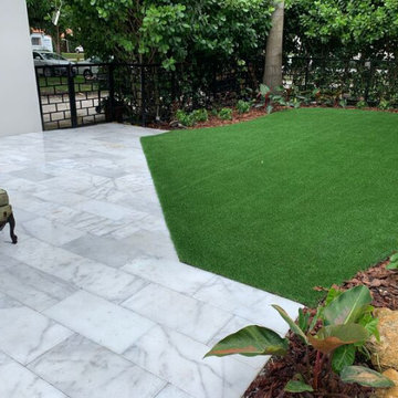 Easy to care artificial grass space for this Tropical landscape area