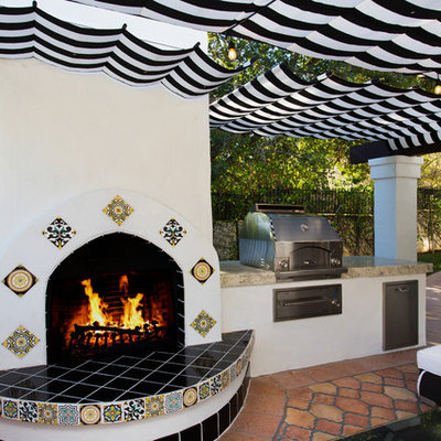 Patio kitchen - large transitional backyard tile patio kitchen idea in Los Angeles with an awning