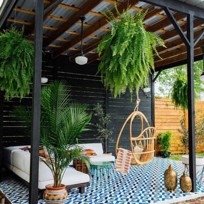 Example of an eclectic tile patio design in New Orleans with a gazebo
