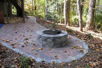 Mid-sized backyard stone patio photo in Baltimore with a fire pit and no cover