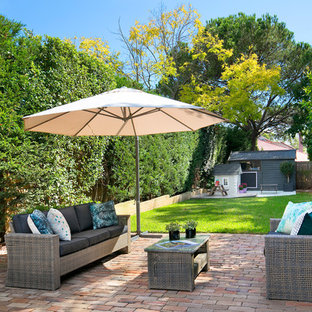 Inspiration for a transitional backyard patio in Sydney with brick pavers.