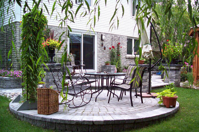 Patio - large modern backyard concrete paver patio idea in Toronto with no cover