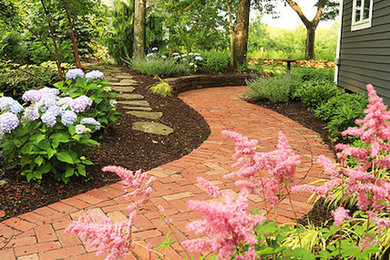 Design ideas for a large classic side patio in Bridgeport with brick paving.