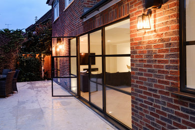Inspiration for a contemporary back patio in Buckinghamshire with concrete slabs.