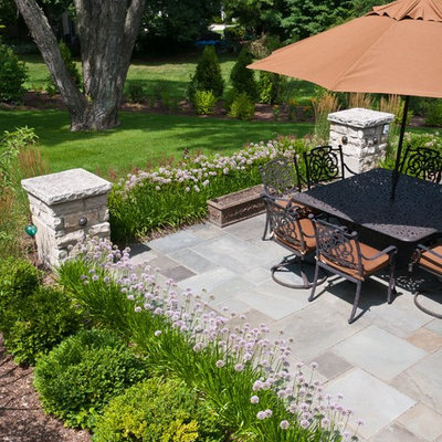 Patio - mid-sized traditional backyard stone patio idea in Milwaukee