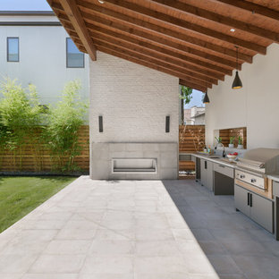 Inspiration for a contemporary backyard concrete paver patio kitchen remodel in Houston