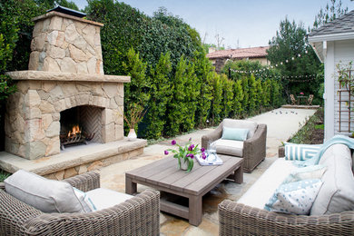 Mid-sized trendy backyard stone patio photo in Los Angeles with a fire pit