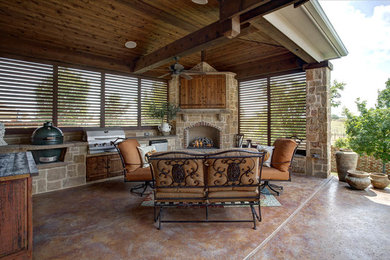 Medium sized contemporary back patio in Dallas with an outdoor kitchen, stamped concrete and a roof extension.