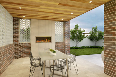 This is an example of a medium sized modern back patio in Brisbane with a fireplace, natural stone paving and a roof extension.