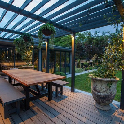 Mid-sized trendy backyard patio photo in Hampshire with decking and a pergola