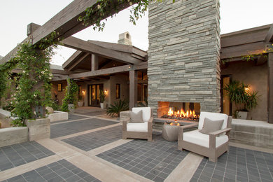 Inspiration for a contemporary patio remodel in Phoenix with no cover and a fireplace