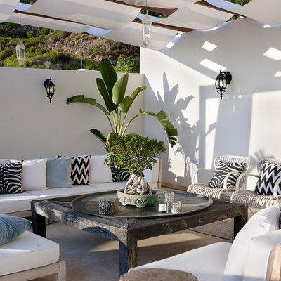 Inspiration for a mediterranean patio remodel in Other with a pergola