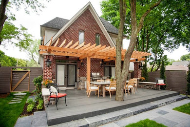 Trendy backyard patio kitchen photo in Toronto with decking and a pergola