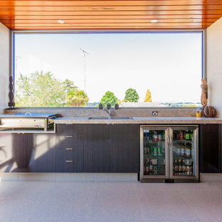 Mid-sized contemporary backyard patio in Melbourne with an outdoor kitchen, tile and a roof extension.