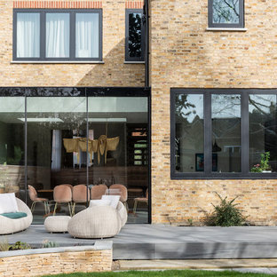Design ideas for a medium sized contemporary back patio in London with decking and no cover.