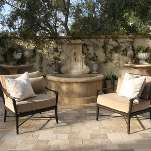 Large tuscan courtyard concrete paver patio fountain photo in Orange County