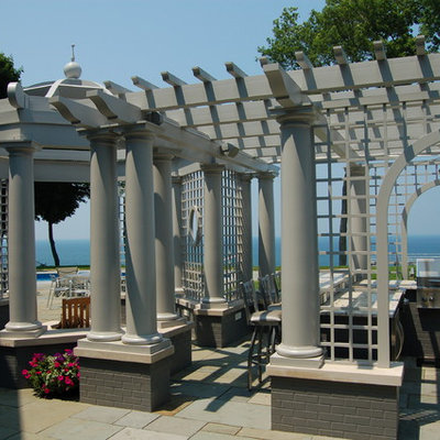 Elegant patio kitchen photo in Grand Rapids with a pergola