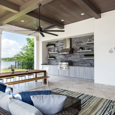 Example of a classic backyard stone patio design in Tampa with a roof extension
