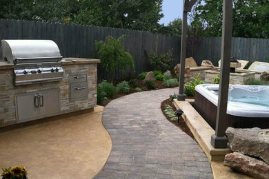 Patio kitchen - mid-sized transitional backyard brick patio kitchen idea in Boise with no cover