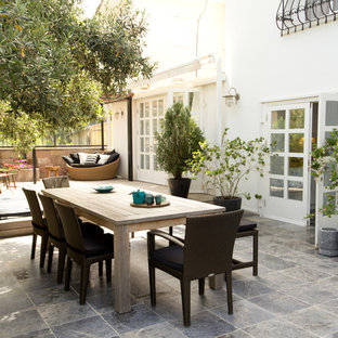 Inspiration for a contemporary back patio in Sussex with tiled flooring and no cover.