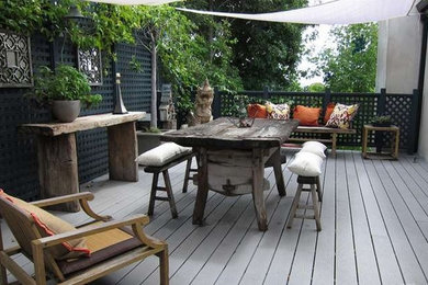 Imagen de patio de estilo zen de tamaño medio con entablado y toldo