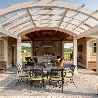 Elegant patio kitchen photo in Other with a pergola