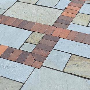 Foto di un grande patio o portico tradizionale dietro casa con pavimentazioni in pietra naturale e nessuna copertura
