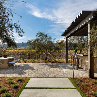 Ispirazione per un ampio patio o portico country dietro casa con ghiaia e un gazebo o capanno