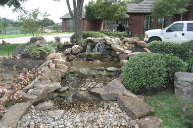 Imagen de jardín rústico en patio delantero con fuente