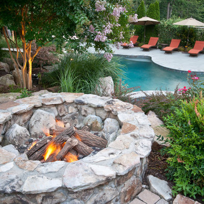 Inspiration for a large timeless backyard brick patio remodel in DC Metro with a fire pit and no cover