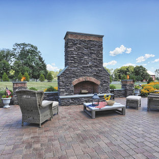 Elegant backyard patio photo in Philadelphia with a fireplace and no cover