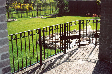 Mid-sized backyard gravel patio fountain photo in Edmonton with a roof extension