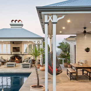 Photo of a transitional patio in Other with an outdoor kitchen, concrete slab and a roof extension.