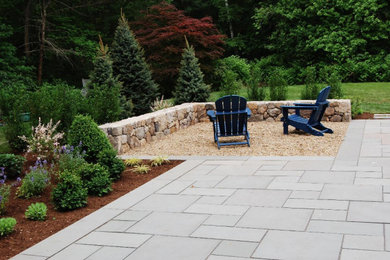 Patio - large traditional backyard stone patio idea in Boston with a fire pit and no cover