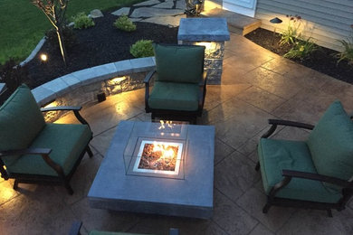 Inspiration for a mid-sized contemporary backyard patio remodel in Philadelphia with a fire pit and no cover
