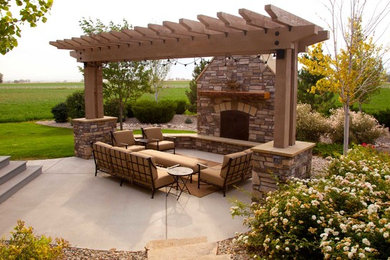 Inspiration for a mid-sized timeless backyard concrete patio remodel in Denver with a fire pit and a pergola