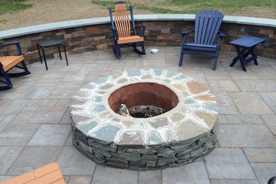 Inspiration for a backyard patio remodel in Providence with a fire pit