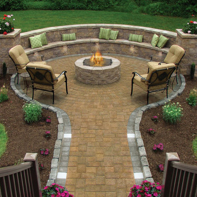 Inspiration for a large timeless backyard stone patio remodel in Providence with no cover