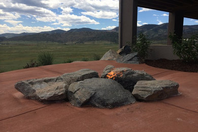 Mid-sized trendy backyard patio photo in Denver with a fire pit and no cover