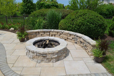 Example of a patio design in Chicago with a fire pit