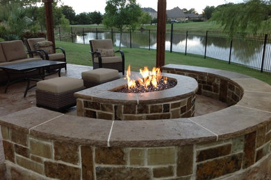 Photo of a medium sized traditional back patio in Dallas with stamped concrete, a gazebo and an outdoor kitchen.