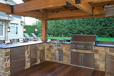 Patio kitchen - large craftsman backyard patio kitchen idea in Nashville with decking and a pergola
