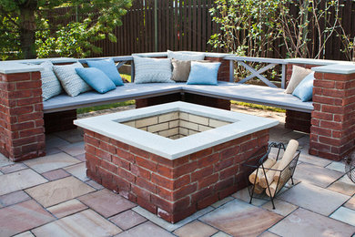 Inspiration for a mid-sized transitional backyard tile patio remodel with a fire pit and no cover